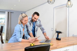 man and women looking at color chart while making home improvements