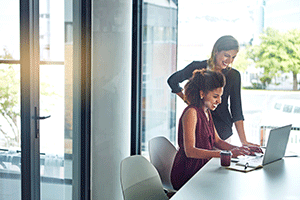 two women working on a laptop