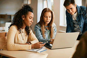 college kids reviewing computer for tech support